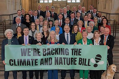 Lib Dem MPs holding Climate and Nature Bill Banner in Parliament