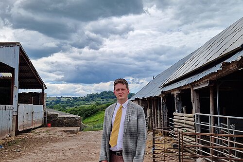 David Chadwick in front of a farm