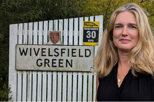 Nadine Stothard at the village sign for Wivelsfield Green