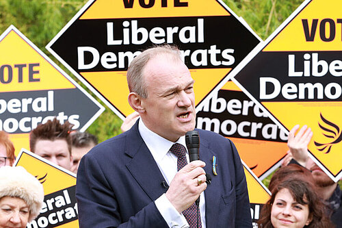 Ed Davey in front of a crowd holding Liberal Democrat posters